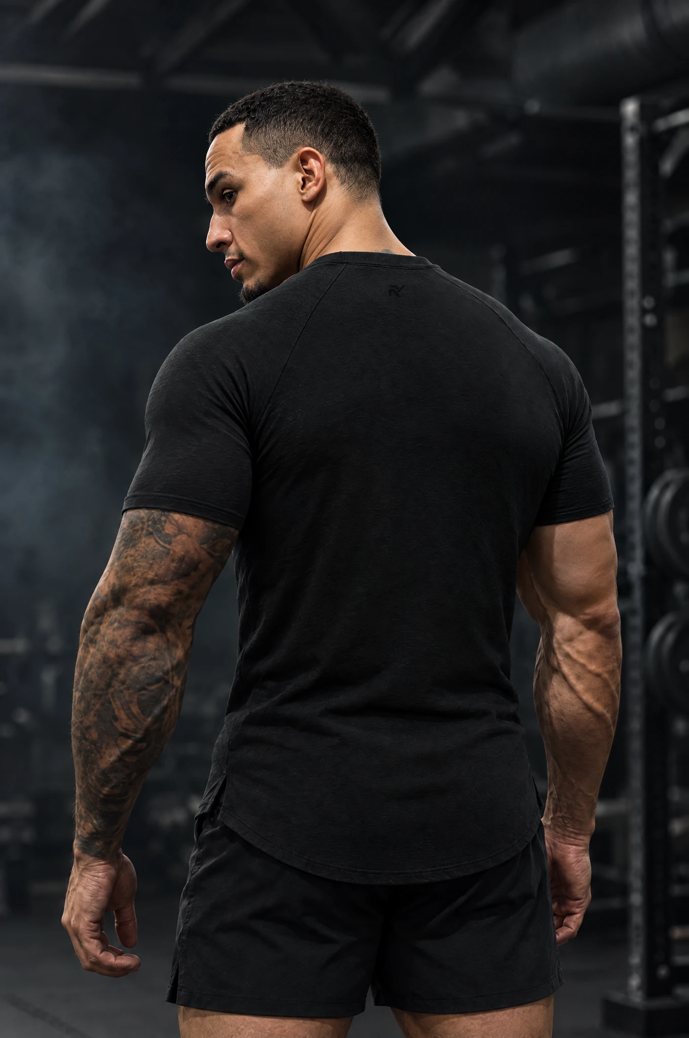 Obsidian Training Tee in Onyx, worn by model, back view looking over the shoulder