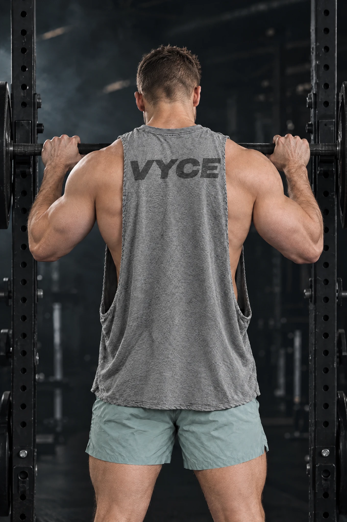 Kyle wearing the Heather Grey Signal Cutoff at the squat rack, back view
