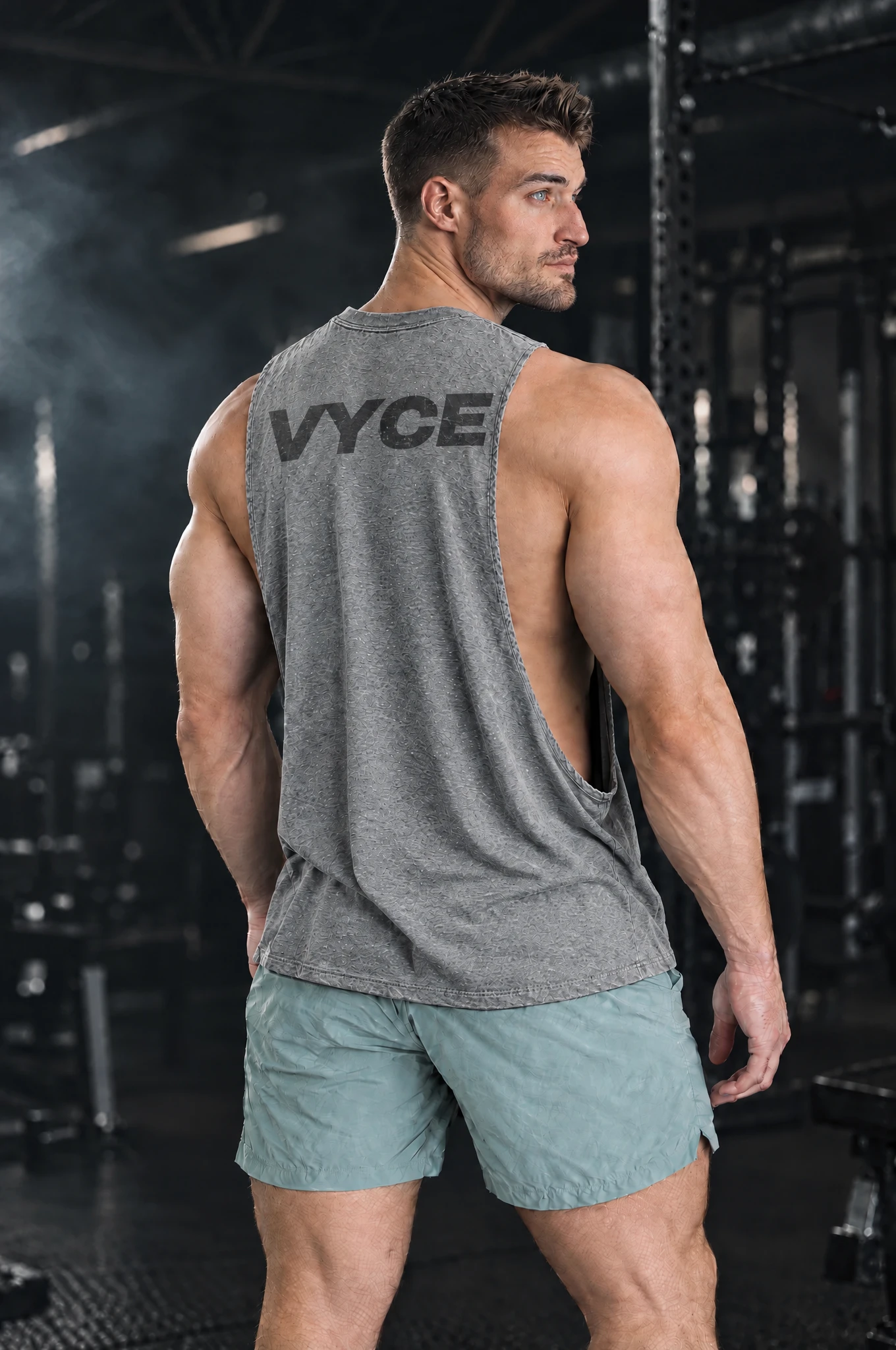 Kyle wearing the Heather Grey Signal Cutoff, back view over the shoulder